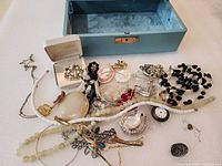 Overview of assorted jewelry pieces and jewelry box