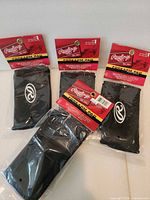 Four packaged Rawlings forearm pads on display