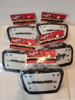 Five packaged Rawlings front kick plates arranged on table