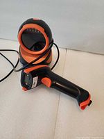 Handheld scanner resting in base showing overall design and color