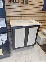 Full view of vanity with countertop, sink, faucet, cabinet