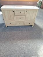 Front view of light oak double sink vanity showing doors, drawers, sinks, hardware