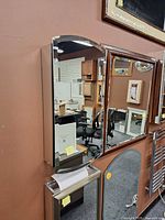 Front view of Alno mirrored cabinet mounted on display wall