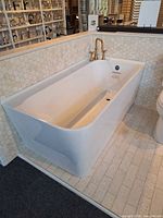 Overall view of white acrylic Fleurco Aria soaking tub installed in showroom display