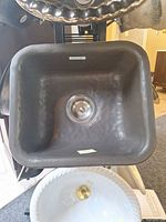 Front view of hammered oil-rubbed bronze porcelain single bowl sink showing drain opening and Bates label