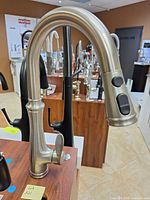 Full view of Kohler Bellera K560-VS pulldown faucet on display board