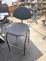 Full view of stool showing seat, backrest, and metal frame