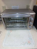 Front view of Black+Decker stainless toaster oven on countertop
