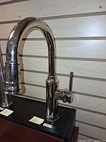 Front view of polished nickel pull-down faucet showing spout, handle, and finish