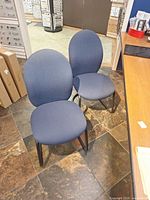 Front view of both blue fabric cantilever chairs