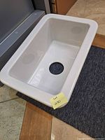 Top view showing white single bowl sink and drain opening