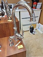 Full view of high-arc chrome faucet mounted on display block