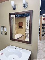 Mirror mounted on wall above sink, showing full view