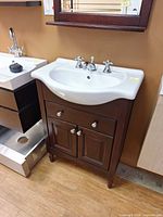 Front view of vanity showing sink, faucet, cabinet