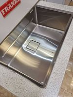 Overall view of the stainless steel sink installed in a demo countertop