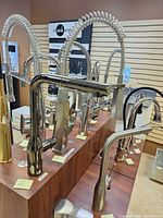 Multiple faucets on showroom counter including Grohe Essence model