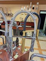 Grohe K7 faucet on display board with spring neck and pull-down spray head