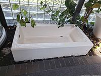 Overall view of biscuit cast iron tub set on display