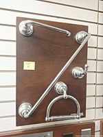 Full view of all four polished chrome accessories mounted on display board