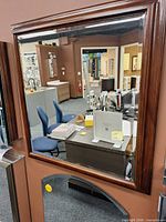 Front view of mirror showing wood frame and reflective surface