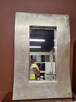 Front view of rectangular silver framed mirror