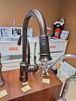 Full view of Moen oil rubbed bronze faucet on display mount