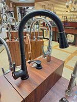 Full view of oil rubbed bronze gooseneck faucet on display stand