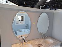 Both scalloped beveled mirrors mounted above vanity