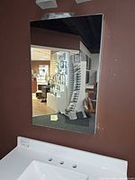 Front view of mirrored medicine cabinet mounted on wall