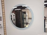 Front view of round Robern mirror showing frosted border and reflective center