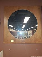 Front view of square alder wood frame with round mirror glass