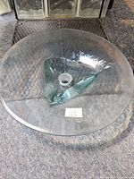 Top view of transparent seafoam glass vessel sink showing textured surface and drain opening