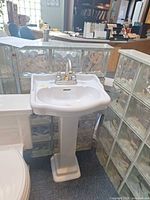 Front view of pedestal sink and faucet