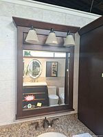 Front view of mirror and integrated three-light fixture