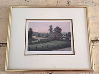 Front view of framed print showing image, matting, and gold frame