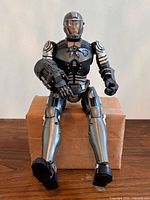 Front view of 15-inch Iron Grenadier figure seated on box