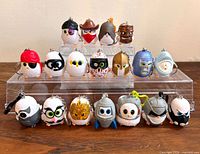 Front view of all 18 Coop Squad owl keychains in two rows