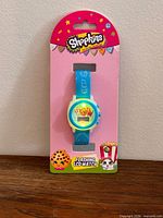 Front view of packaged Shopkins flashing LCD watch on card