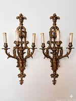 Pair of matching three-arm gilt wall sconces