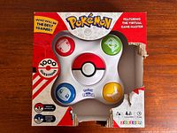 Front of torn box showing electronic game unit, branding, 1,000 questions callout