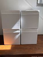 Front view of four white storage cubes stacked two by two