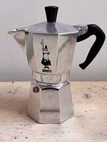 Full view of Bialetti Moka Express pot showing overall condition, handle, knob and logo