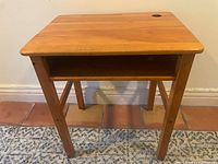 front view of solid wood child’s desk showing top, shelf, legs