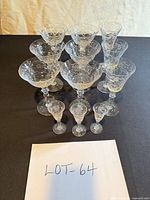 Full set of 11 etched floral stem glasses displayed