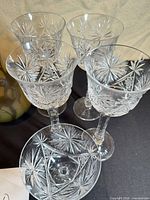 Close view of cut crystal starburst wine glasses and coupes