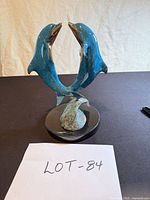 Front view of entire dolphin sculpture on base