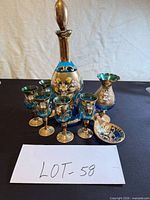 entire set grouped showing decanter, stopper, six cordials, vase, dish