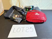 All four items laid out: Burton jacket and pants, Giro goggles, Kiva pouch