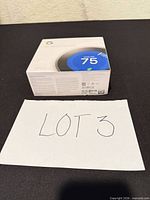 Front of sealed Nest Learning Thermostat box showing product image and temperature display
