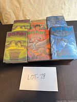 Six Harry Potter hardcovers grouped on table showing front dust jackets